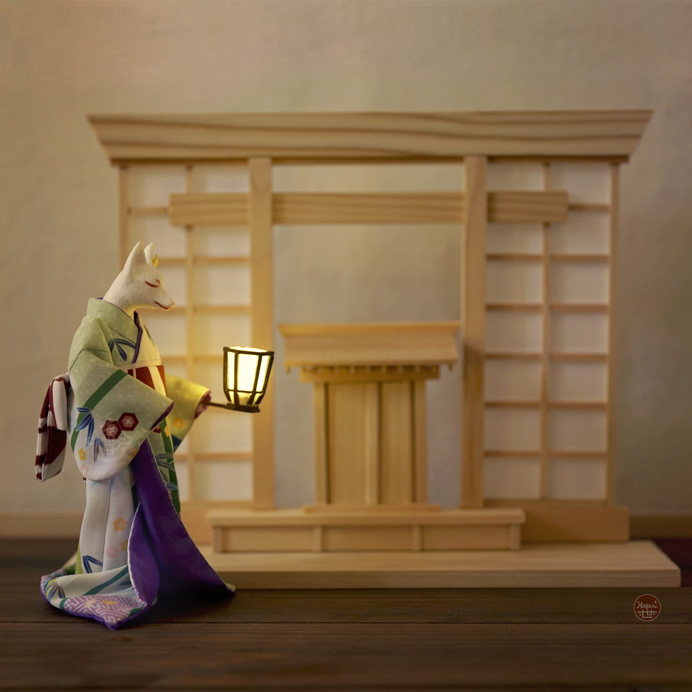 Kimono-wearing fox figure holding a small candle stand, standing in front of a shrine-inspired wooden display