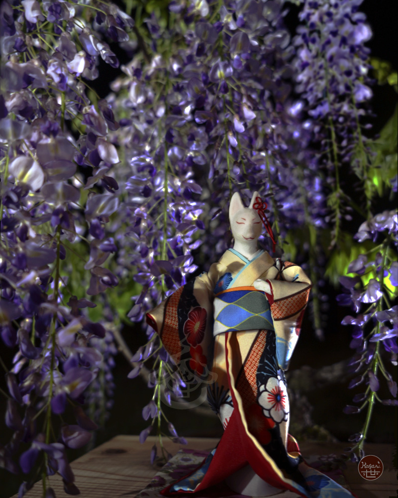 Fox in a plum blossom kimono standing beneath illuminated purple wisteria flowers