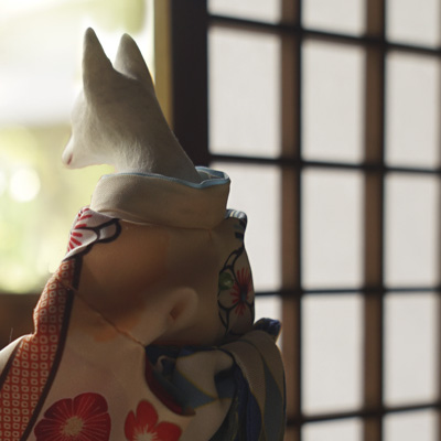 Fox looking outside from a tatami room with an open letter and temari ball