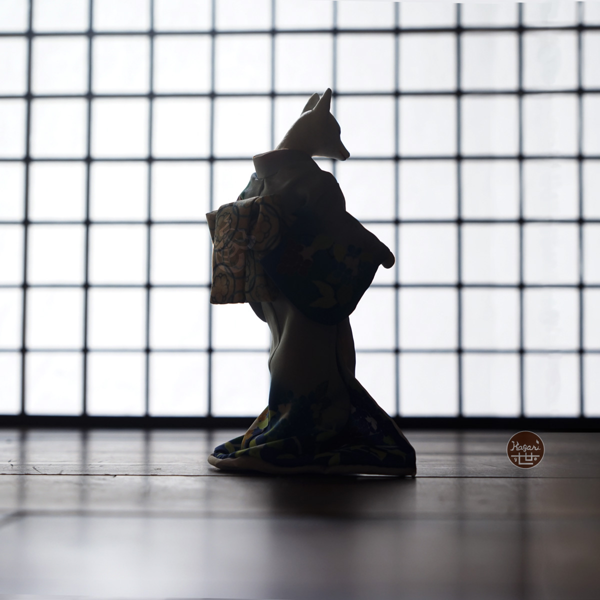 Silhouette of a kimono-wearing fox figure seen from behind against a soft white shoji screen grid